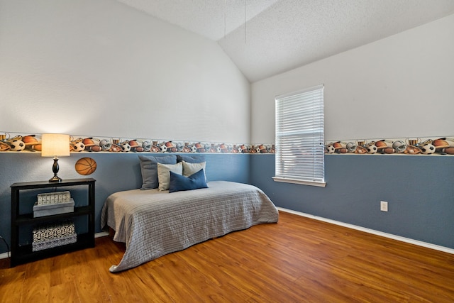 bedroom with wood-type flooring, a textured ceiling, and lofted ceiling