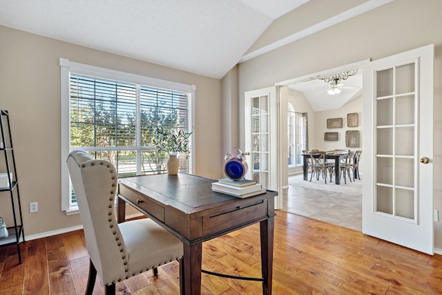 office area featuring ceiling fan, french doors, wood-type flooring, and lofted ceiling