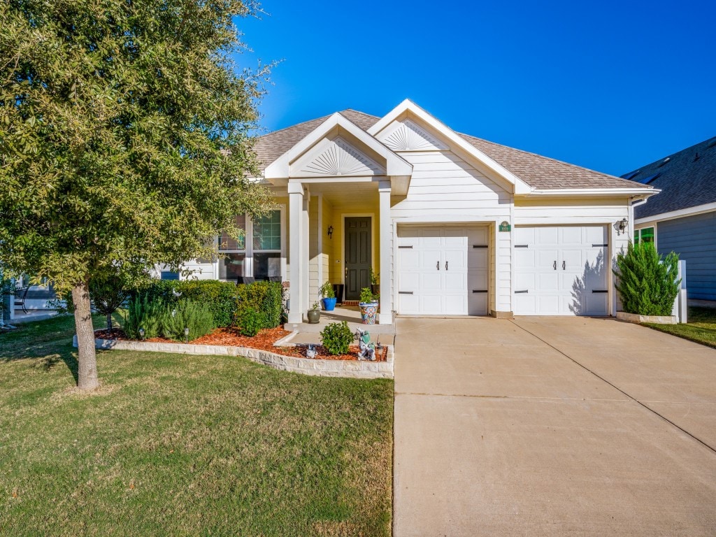 view of front facade with a front lawn and a garage