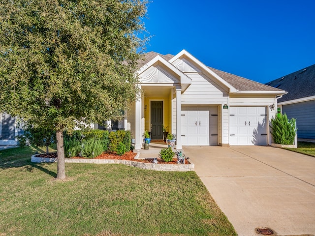 view of front facade featuring a front yard and a garage