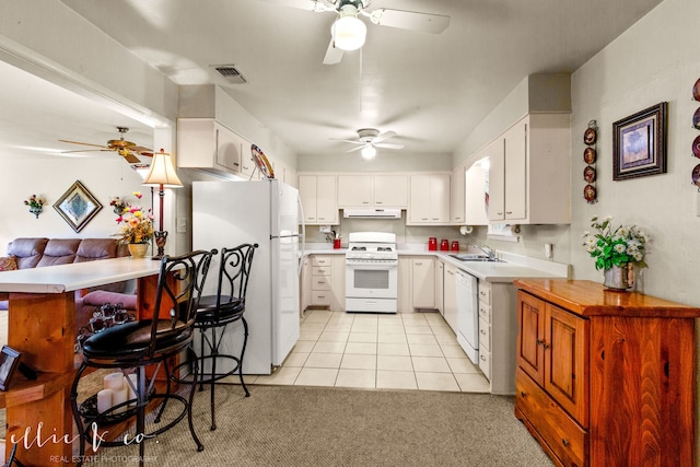 kitchen with white cabinets, light colored carpet, white appliances, and sink