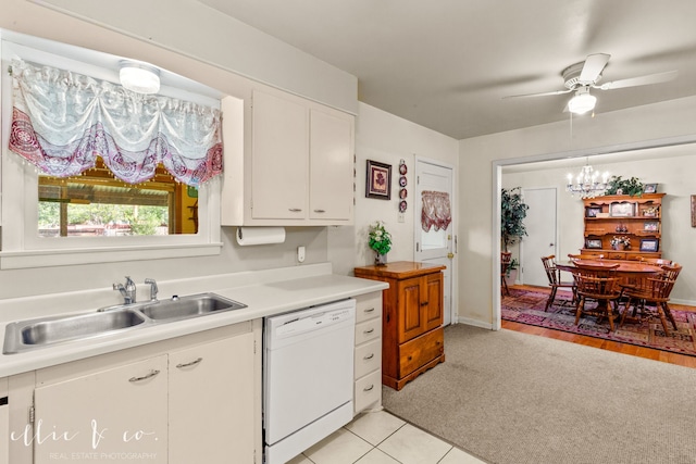 kitchen featuring ceiling fan, dishwasher, sink, light tile patterned floors, and white cabinets