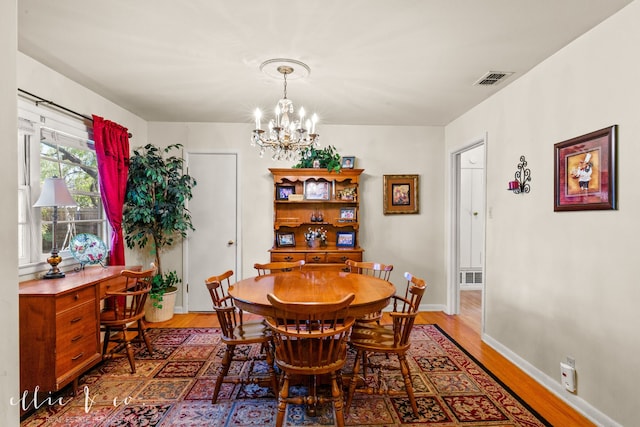 dining space featuring a chandelier and hardwood / wood-style flooring