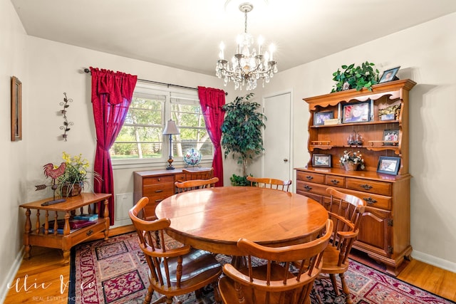 dining room with an inviting chandelier and hardwood / wood-style flooring