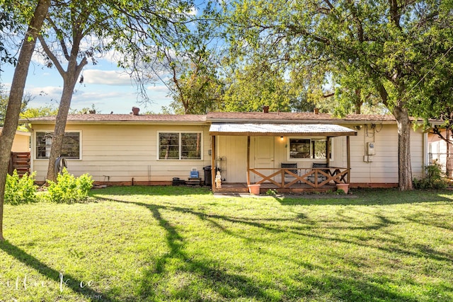 back of property featuring a lawn