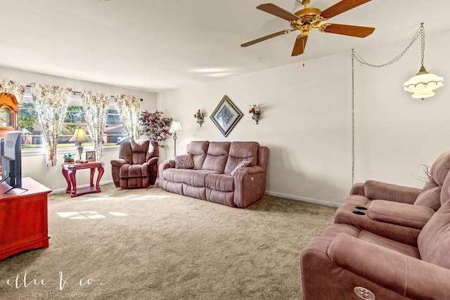 carpeted living room with ceiling fan