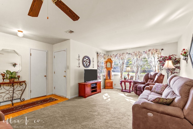 living room featuring ceiling fan and light wood-type flooring