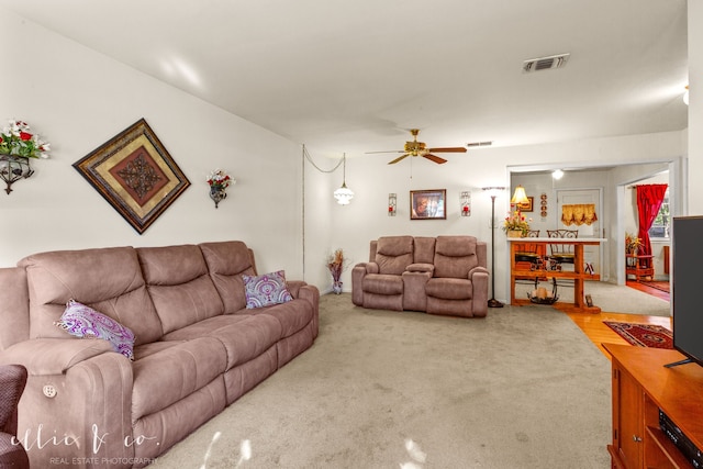 living room featuring carpet and ceiling fan