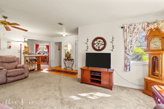 living room featuring light carpet and ceiling fan