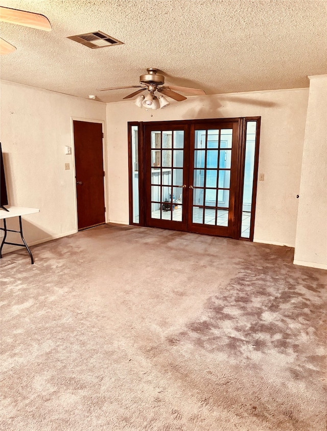 unfurnished living room with carpet flooring, ceiling fan, and a textured ceiling