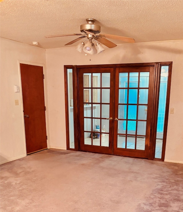 doorway to outside with a textured ceiling, ceiling fan, light carpet, and french doors