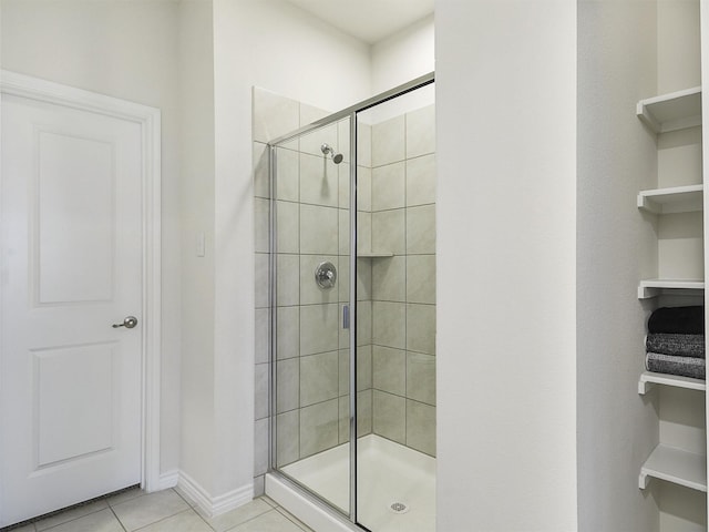 bathroom with tile patterned flooring and a shower with door