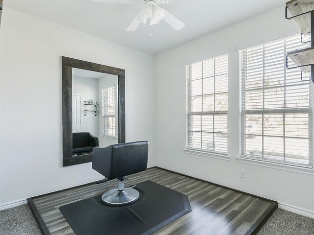 home office with ceiling fan and dark hardwood / wood-style flooring