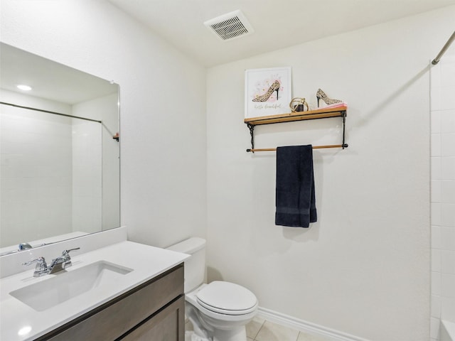 bathroom featuring tile patterned floors, vanity, toilet, and a shower