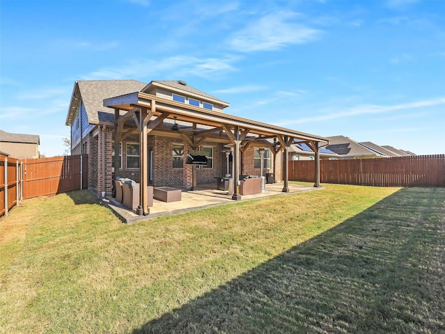 rear view of house featuring a lawn and a patio