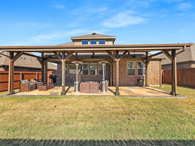 rear view of house with a lawn, an outdoor living space, ceiling fan, and a patio