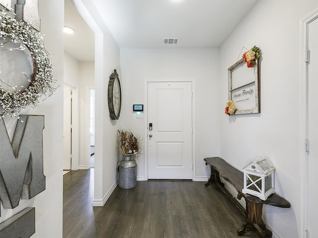 entryway with dark hardwood / wood-style flooring