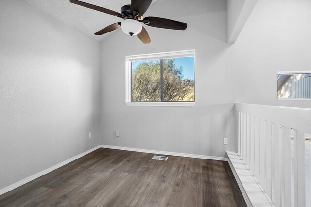 empty room featuring a textured ceiling, ceiling fan, hardwood / wood-style floors, and lofted ceiling