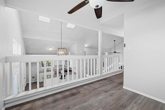 corridor featuring dark hardwood / wood-style flooring, high vaulted ceiling, and an inviting chandelier