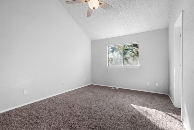 carpeted spare room featuring ceiling fan, a textured ceiling, and vaulted ceiling