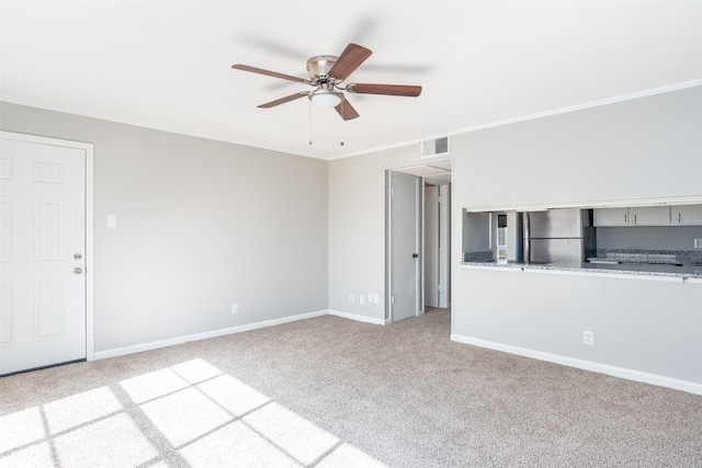 unfurnished living room with ceiling fan, ornamental molding, and light carpet