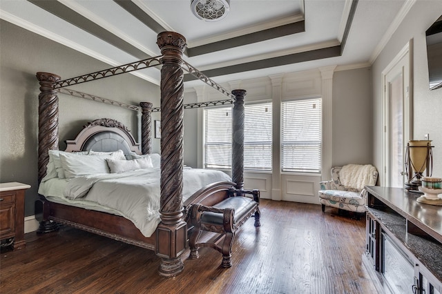 bedroom with crown molding, dark wood-type flooring, and a tray ceiling