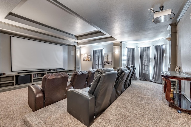 carpeted cinema room with a textured ceiling, a tray ceiling, and crown molding