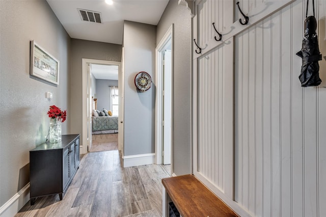 mudroom with light hardwood / wood-style flooring