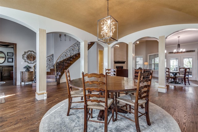 dining room with a notable chandelier, dark hardwood / wood-style floors, french doors, and vaulted ceiling