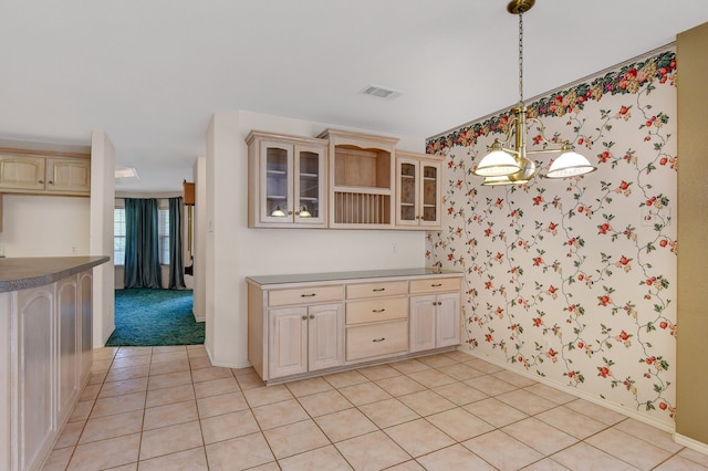 kitchen featuring light brown cabinetry, light tile patterned floors, and hanging light fixtures