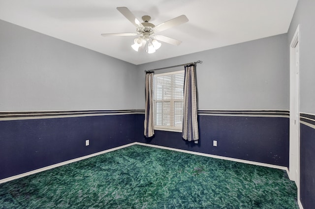 unfurnished room with ceiling fan and carpet