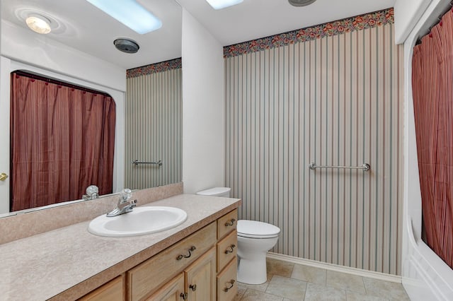 bathroom featuring tile patterned floors, vanity, and toilet