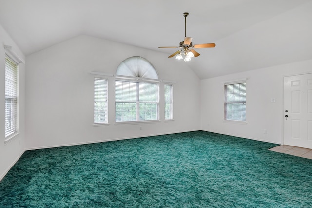 empty room featuring plenty of natural light and vaulted ceiling