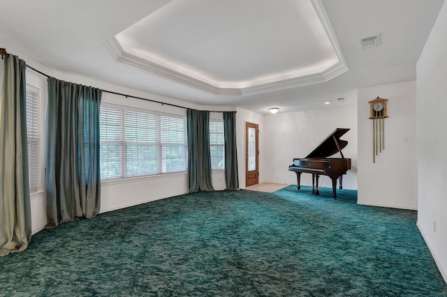 misc room featuring carpet, a raised ceiling, and crown molding