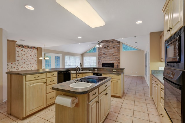 kitchen featuring lofted ceiling, a center island with sink, black appliances, hanging light fixtures, and ceiling fan