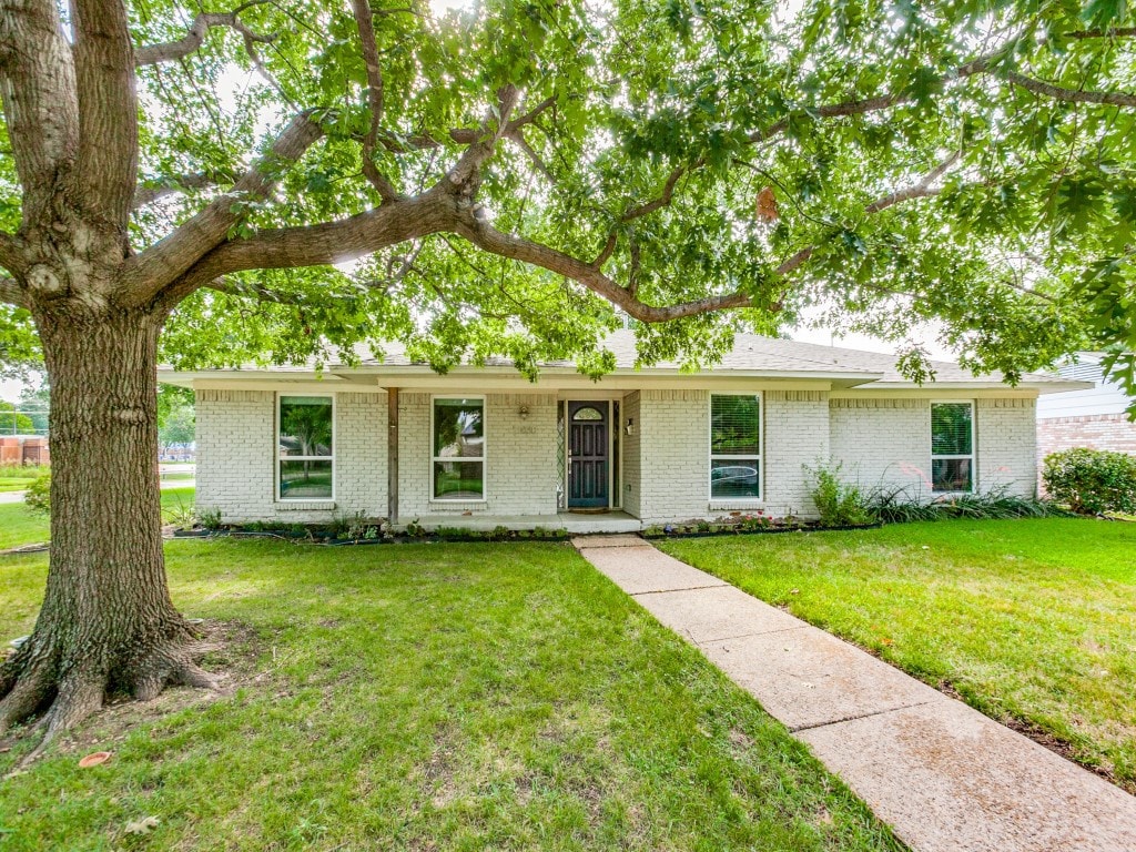 single story home featuring a front lawn