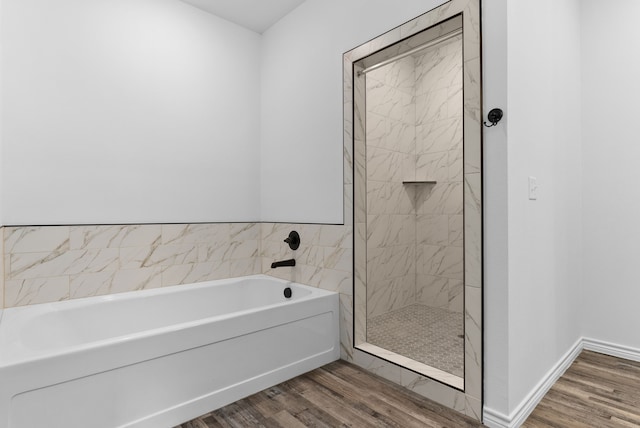 bathroom featuring hardwood / wood-style flooring and independent shower and bath