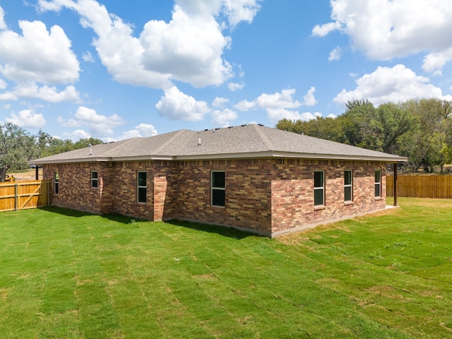 rear view of house with a yard