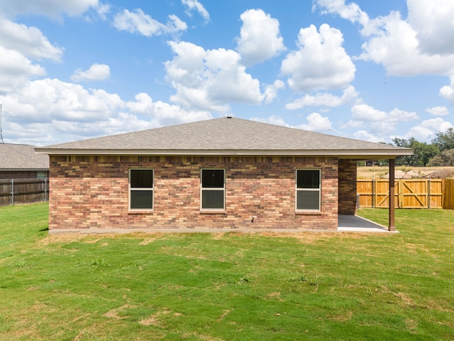 back of house featuring a patio area and a yard