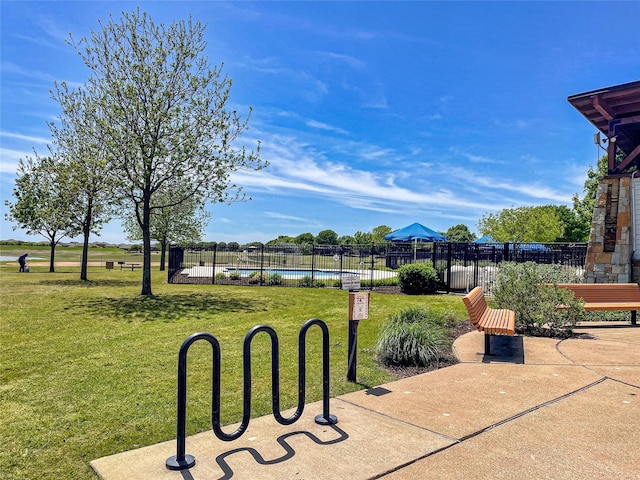 view of property's community featuring a pool and a lawn