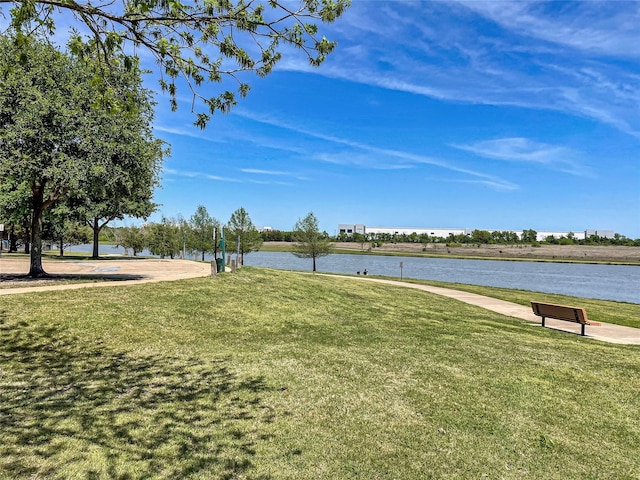 exterior space featuring a lawn and a water view