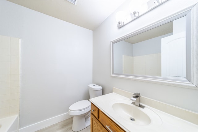 full bathroom with vanity, toilet, tub / shower combination, and hardwood / wood-style floors