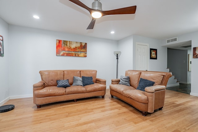 living room featuring ceiling fan and light hardwood / wood-style flooring