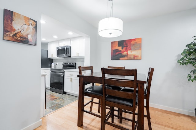 dining space featuring light wood-type flooring