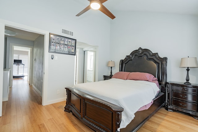 bedroom with light wood-type flooring, vaulted ceiling, and ceiling fan