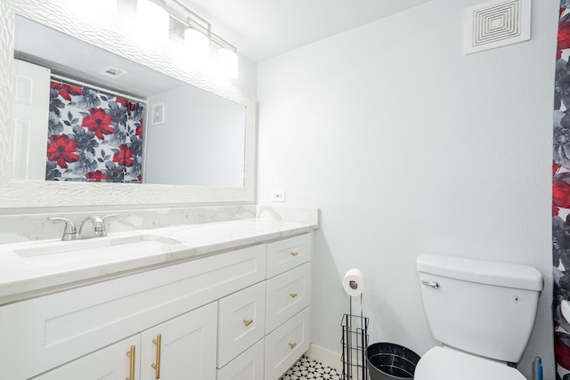 bathroom featuring vanity and toilet