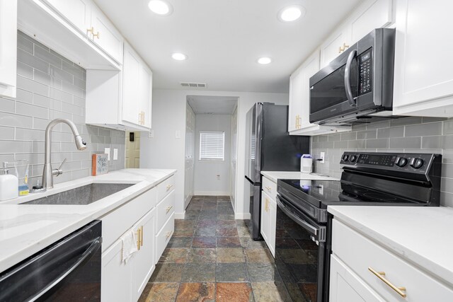 kitchen with black appliances, backsplash, white cabinetry, and sink