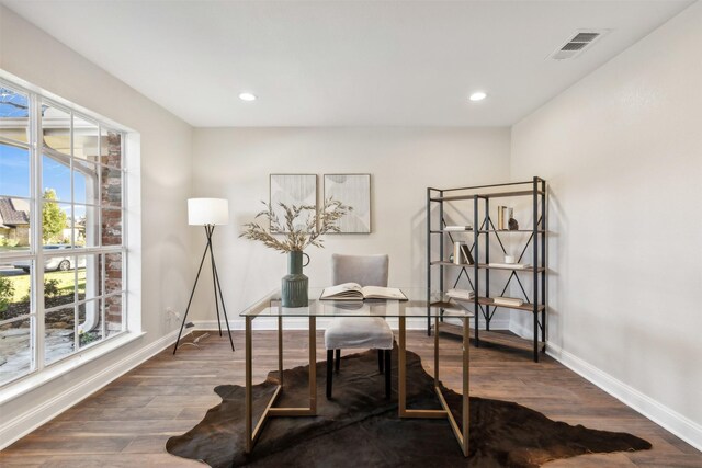 home office with dark hardwood / wood-style flooring