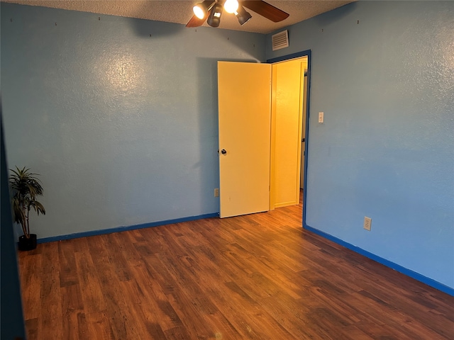 spare room featuring ceiling fan, a textured ceiling, and hardwood / wood-style flooring