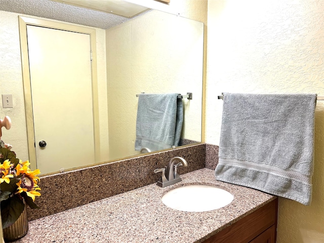 bathroom featuring vanity and a textured ceiling